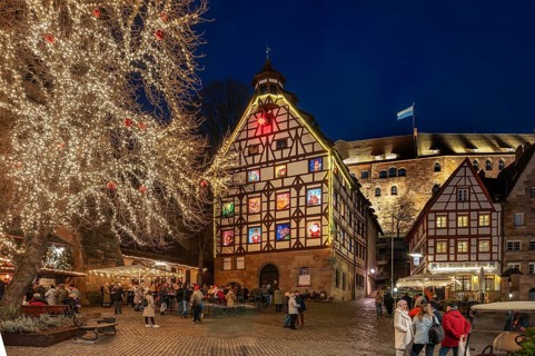 Historic Pilkatushaus with an Advent calendar on 18 December 2024 at dusk, behind the Imperial