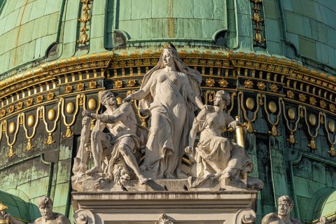 Statues on the dome of St Michael's Wing of the Hofburg Imperial Palace Palace in Vienna, Austria,