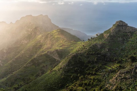 View of the Barranco Juan de Vera and its mountains, palm trees, rocks and sea. Near Mirador