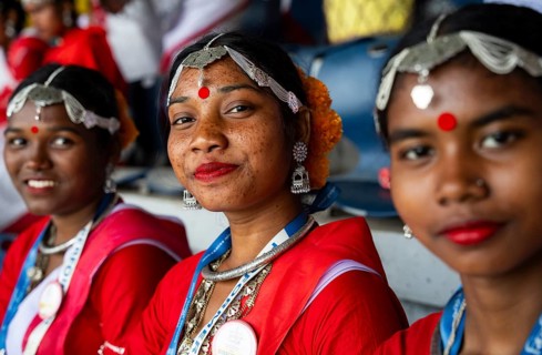 Girls from tea tribe community wearing traditional attire, wait to perform traditional Jhumur