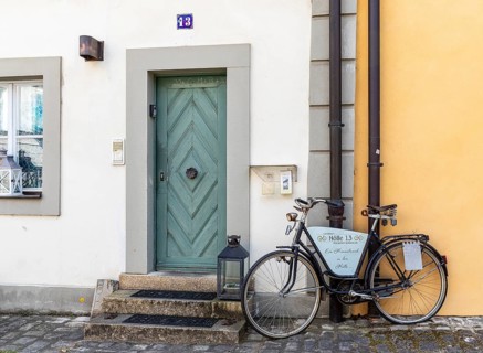 Bicycle as decoration in front of the guest house Hölle 13 in the mountain town of Bamberg,