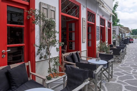 Inviting café with red façade and outdoor seating, Parikia, Paros, Cyclades, Greece, Europe
