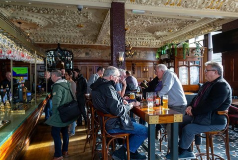 Customers in public bar inside Crown Hotel pub in city centre of Liverpool, England, UK