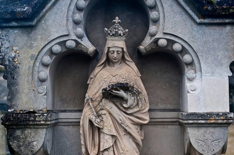Sculpture depicting the Virgin Mary reading a book, tombstone in a cemetery, France, Europe