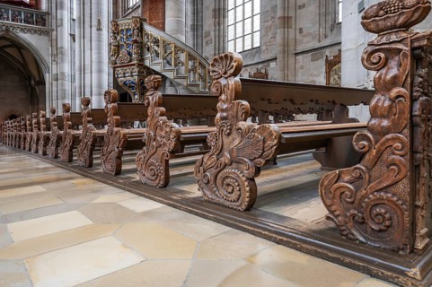 Cheeks of the pews in the late Gothic hall church of St George, Dinkelsbühl, Bavaria, Germany,