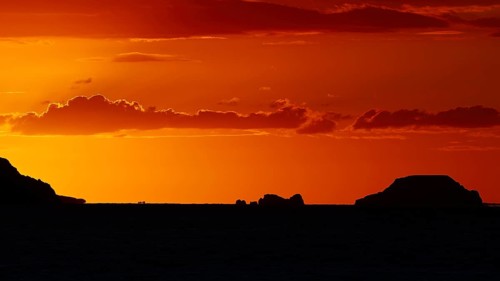 Tranquil island landscape at sunset, soft orange tones in the sky over the sea, sunset, Kassos,