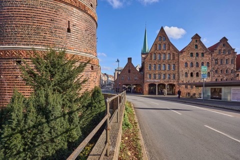 Holstentor city gate with historic salt stores, brick building, railings, Holstentorplatz street,