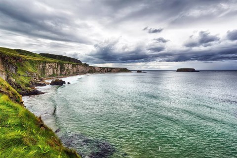 View of the sea, cliff coast, chalk cliffs, dramatic cloudy sky, rain clouds, Causeway Coastal