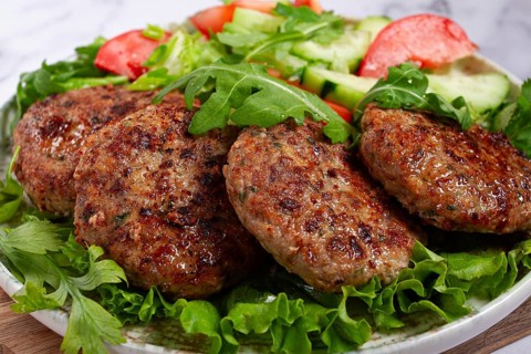 Fried cutlets, mixed minced meat, with vegetable salad, homemade, top view, no people