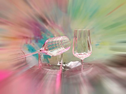 Light art, various glasses on silver foil, behind them various splashes of colour, zoom effect,