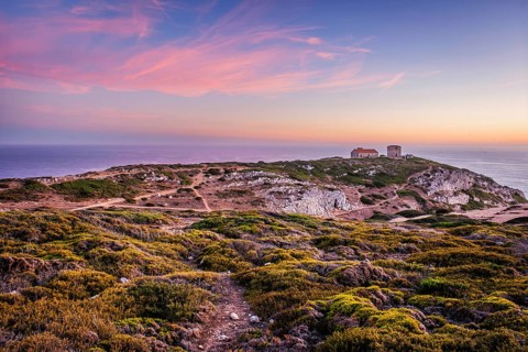 Cabo Espichel cape Espichel on Atlantic ocean at sunset with ruins