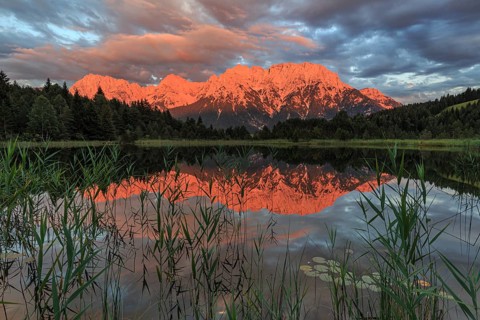 Mountains and clouds reflected in lake, evening light, cloudy mood, summer, Luttensee, Mittenwald,