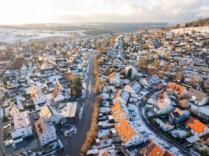 Snow-covered village with a main road dividing it into two halves, Calw- Stammheim, Black Forest,