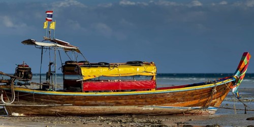 Longtail boat on the beach, at low tide, Koh Ngai Island, Andaman Sea, Satun Province, Southern
