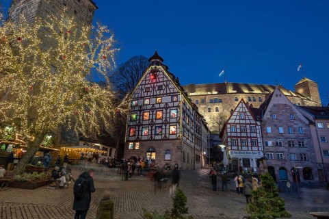 Historic Pilatus House with an Advent calendar designed by the Altstadtfreuden Nuremberg, behind