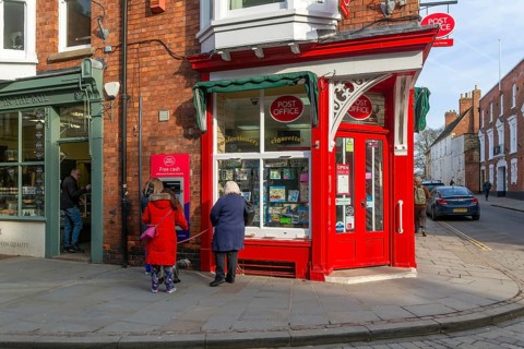 Post Office corner shop painted bright red, Eastgate, Bailgate, Uphill area of city of Lincoln,