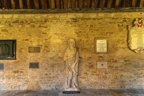 Statue of St John the Baptist in the cloisters of New College, University of Oxford, Oxfordshire,