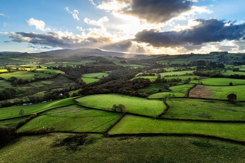 Farms over Trecastle from a drone at sunset, Brecon Beacons National Park, Powys, Wales, England,