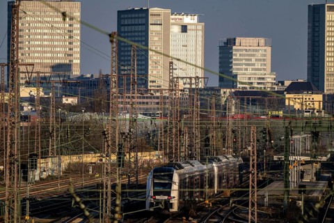 Regional express train on the tracks west of Essen central station, skyline of the city centre,
