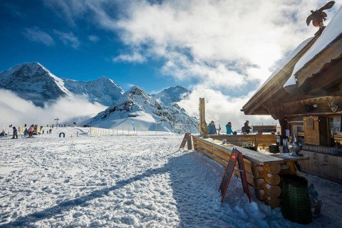 Wooden chalet and ski slope, with views of the Eiger, Mönch and Tschuggen, Grindelwald, Bernese