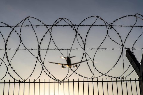 Symbolic image security at the airport, outer fence at Düsseldorf International Airport, steel wire