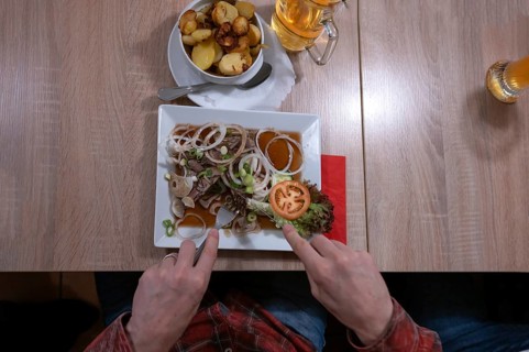 Pork brawn with onion and fried potatoes served in a Franconian restaurant, Bavaria, Germany,