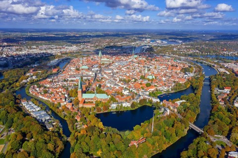 Aerial view over the river Trave and church towers in the old town of the Hanseatic City of Lübeck