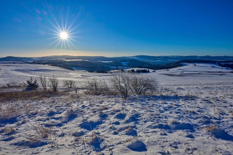 Snow-covered hills under a bright sun and clear sky, winter, Wasserkuppe, Gersfeld, Rhön, Hesse,