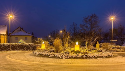 Advent candles at the roundabout, illuminated, snowy and at dusk, Coswig, Saxony, Germany, Europe