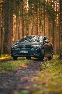 Car on a forest path at sunrise, surrounded by lively foliage, car sharing vehicle Deer Mobility,