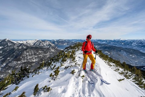 Ski tourer at the summit of Simetsberg, mountain panorama, Estergebirge, Bavarian Prealps, Bavaria
