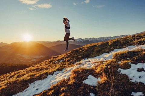 Trail running in autumn on the Jochberg on Lake Walchensee against the wonderful backdrop of the