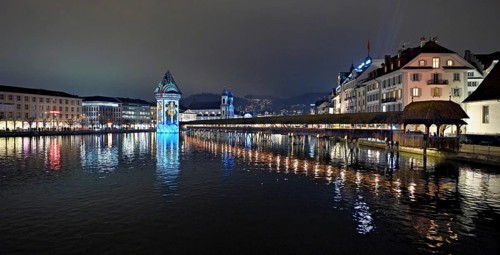 Wassertum with light installation, Chapel Bridge on the right, Jesuit Church on the Reuss at dusk