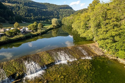 Camping site Moulin du Doubs and weir at the river Doubs near Ocourt seen from the air,