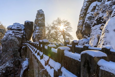 Winter morning on the Bastei bridge with morning sun and Neurathen rock gate, Saxon Switzerland,