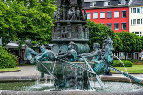 Detail of the historical column of the fountain on Josef-Görres-Platz in the historic centre of