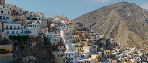 Tightly packed houses on the mountainside of the Mediterranean and picturesque village of Olymbos,