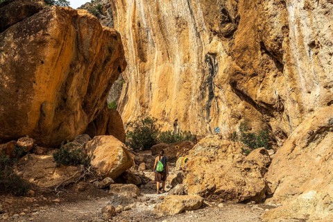 Tourist on the hiking trail through the gorge of Lissos near Sougia, Crete, Greece, Europe