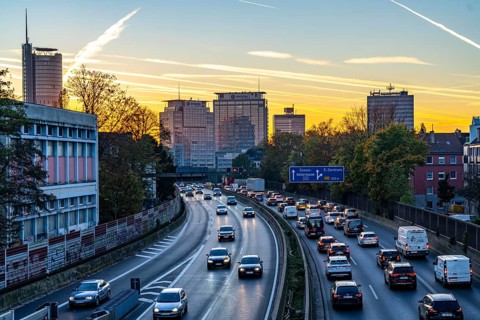 Evening traffic, partly with traffic jams, slow-moving traffic on the A40 motorway, skyline of