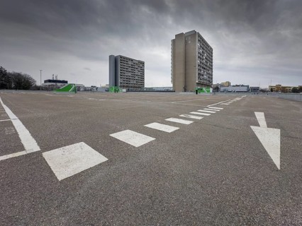 Symbolic image economic crisis, dark clouds in the sky, empty parking deck at