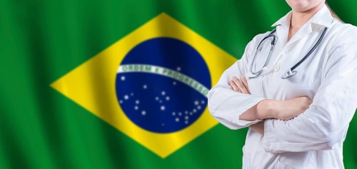 Doctor with crossed arms on Brazilian flag. Brazilian Health and Care concept. Female doctor on
