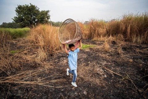 Villagers participate in a community fishing event on the occasion of the Bhogali Bihu festival at