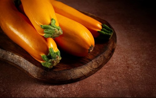 Yellow zucchini, fresh, raw, on a wooden chopping board, no people