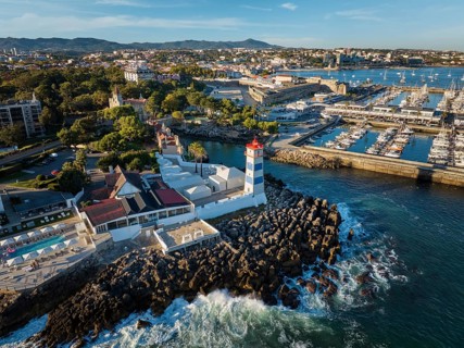 Aerial view of Santa Marta lighthouse and Cascais marina with moored yacht boats with Cascais