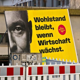 Large FDP election poster with Christian Lindner for the 2025 Bundestag election behind a barrier,