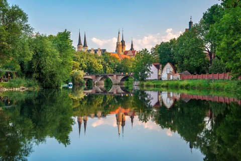 Merseburg Cathedral and Merseburg Castle reflected in the river Saale in the morning light,
