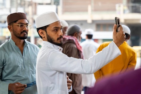 GUWAHATI, INDIA - MARCH 2: A Muslim person takes selfie, as he arrives for Ramadan's first Iftar