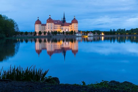 Moritzburg Hunting Lodge with reflection in the castle pond in the evening, Moritzburg, Saxony,