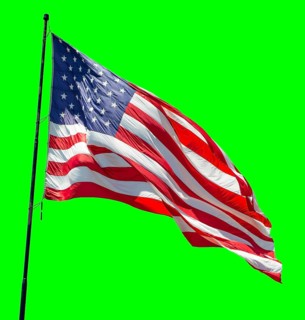 American flag waving in the wind on a flag pole over a green screen