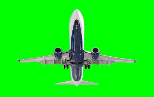 Passenger airplane either taking off or landing over a green screen